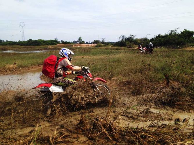 dirt-bike-tours-cambodia-muddy-fields